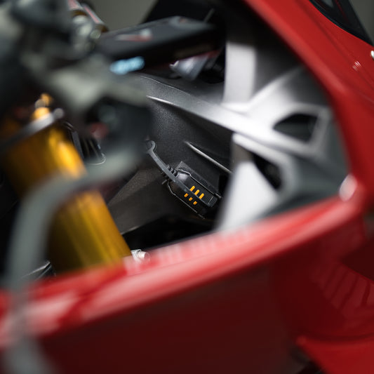 CTEK connector mount installed inside red motorcycle bodywork